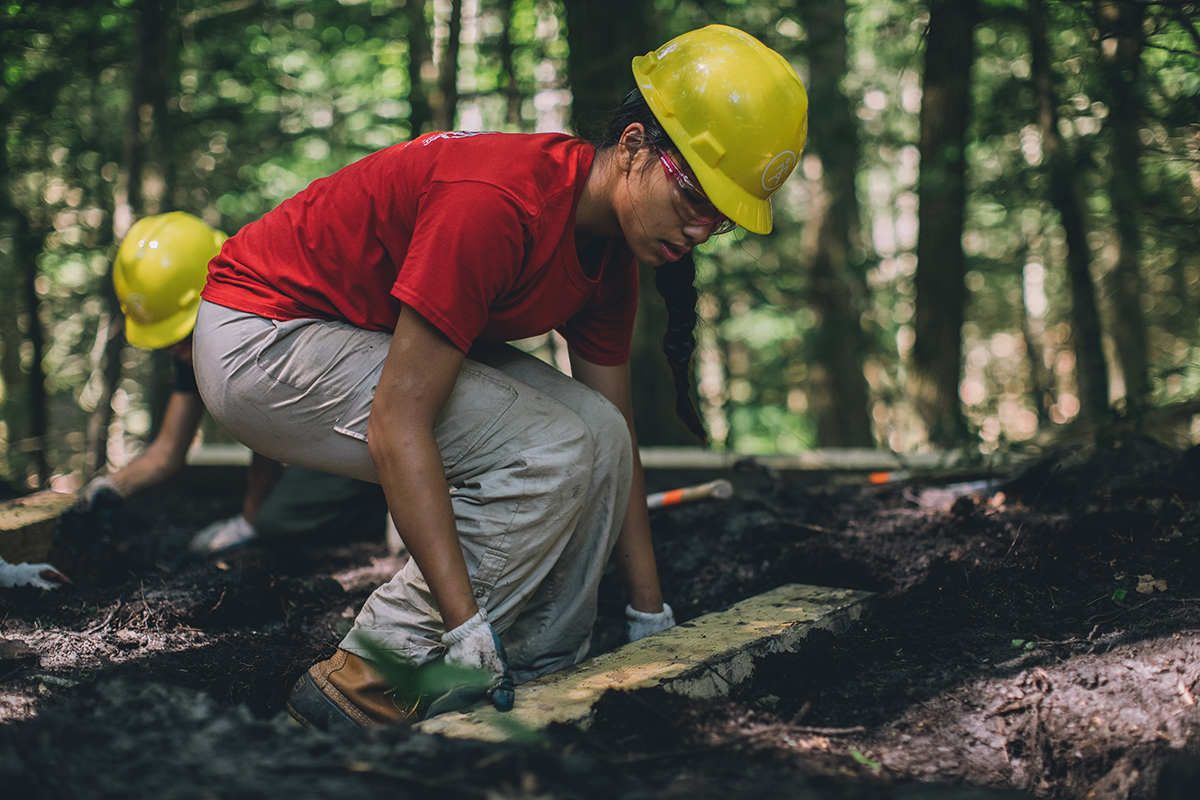 A woman doing trail work