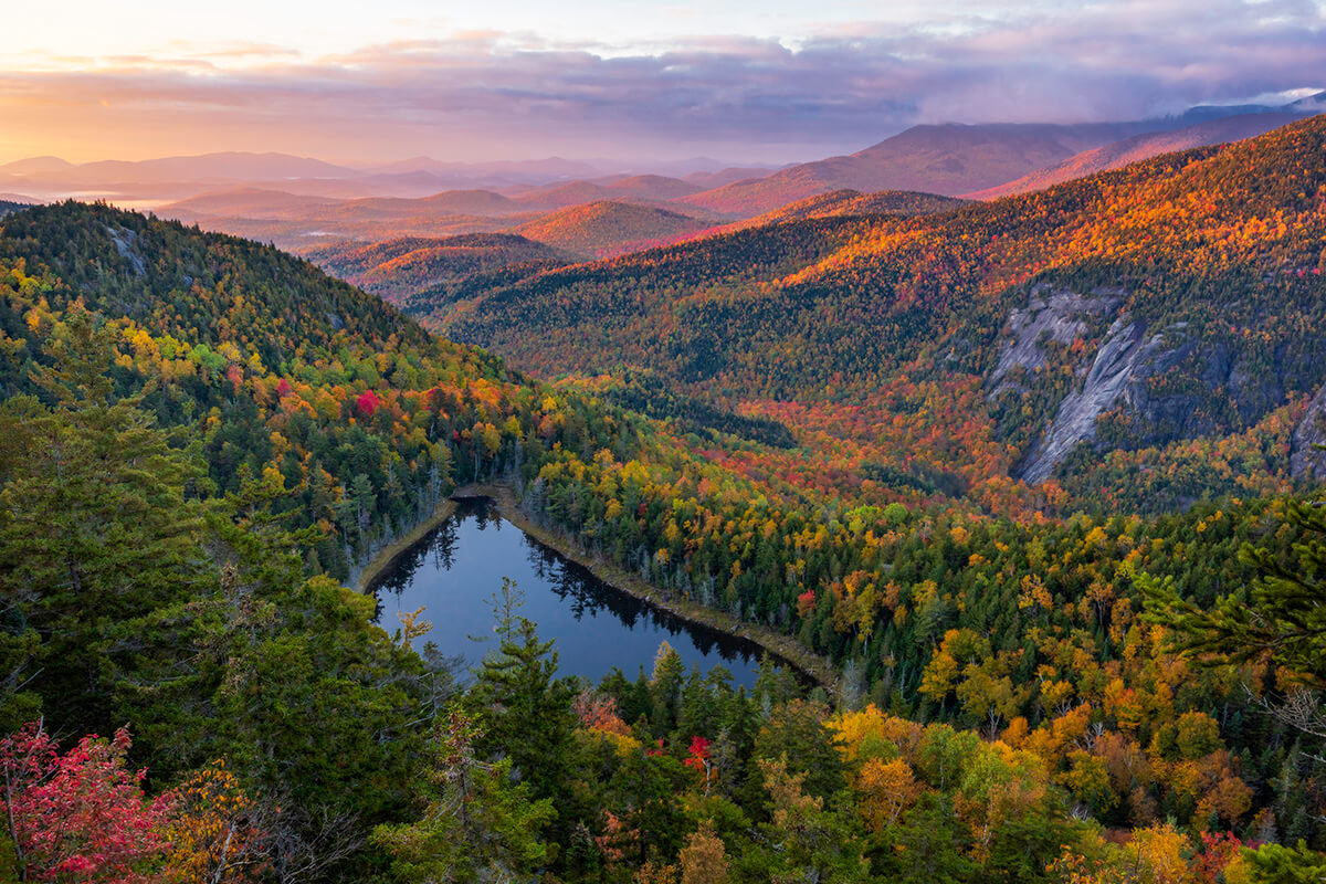 autumn sunrise over foliage in High Peaks Wilderness, Adirondack Mountains, New York