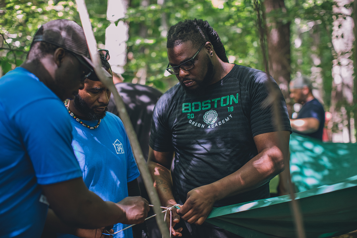 group learning how to set up a tent in Blue Hills Reservation, MA