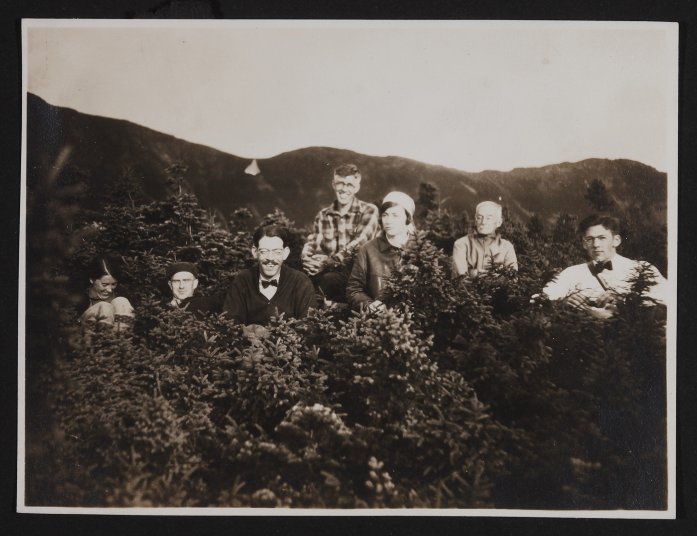 AMC LIBRARY AND ARCHIVESHikers rest in the krummholz along the abandoned route of the Old Bridal Path on Mount Lafayette in 1920